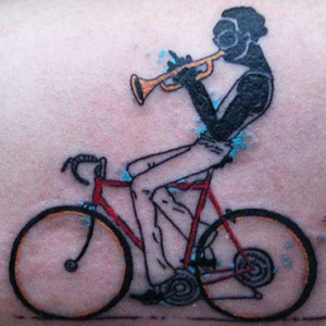 Musical guy on a bike tattoo