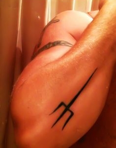 Trident tattoo on forearm